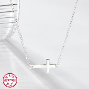 Detailed macro view of 925 sterling silver necklace showing side-ways cross pendant