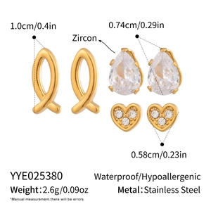 Detail view of 3-pair gold earring set with zircon fish, pear, and heart shape studs