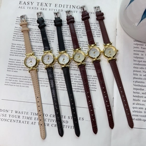 Flat lay of vintage women's quartz watches with assorted embossed leather straps