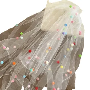 White bridal veil with colorful pom-poms for birthday parties and wedding photo shoots