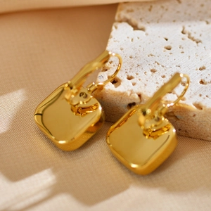 Close-up of gold geometric square earrings featuring the 925 silver hallmark engraving