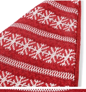 Macro shot of red and white knitted Christmas fabric with snowflake and geometric patterns