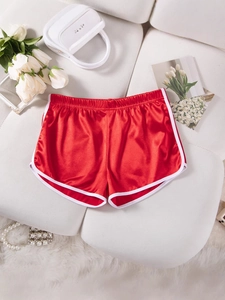 Women's sexy red satin sports shorts with white trim in a flat lay display