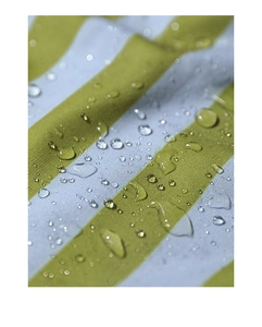 Macro view of yellow and white striped fabric showing superior water-repellent droplets