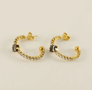 Detail of 18K gold-plated C-shaped earrings with black square stone and pavé crystals