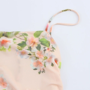 Dettaglio dell'abito floreale rosa con spalline sottili e delicati motivi a petali