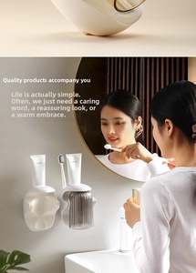 Detail of wall-mounted magnetic mouthwash cup holder with organized toothbrush storage