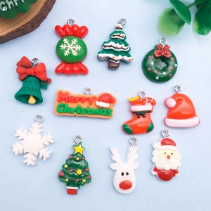 Flat lay of colorful Christmas resin charms including Santa, Reindeer and festive trees