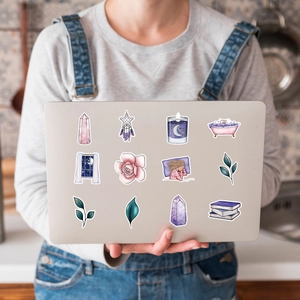 Artistic purple fantasy stickers applied on a laptop case for creative decoration