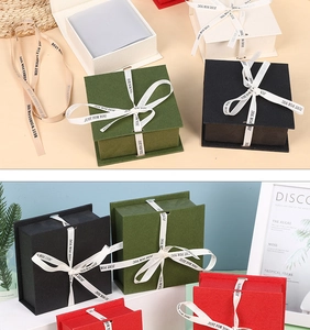 Detail of elegant flip-top gift boxes with decorative ribbons in multiple colors
