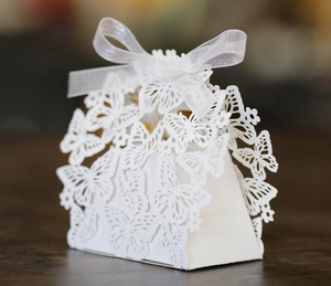 Detailed laser-cut butterfly gift box with elegant white ribbon bow and hollow design