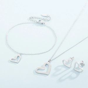 Detailed close-up of a silver hollow heart necklace, bracelet and earring jewelry set