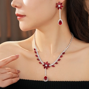 Close-up of vintage flower and teardrop jewelry set with red rubies and white diamonds