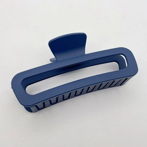 Detail view of large rectangular blue matte hair claw clip with sturdy grip teeth