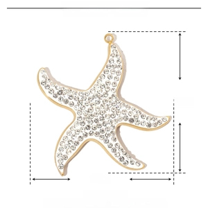 Macro shot of 34mm gold-plated starfish pendant with crystals and stainless steel detail