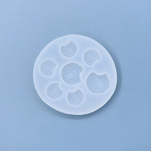 Detailed macro view of a 7-cavity silicone mold featuring bitten biscuit shapes with text