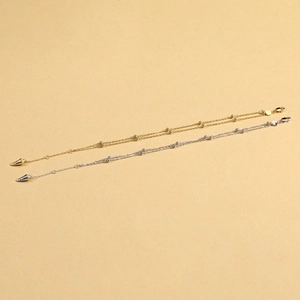 Double-layered 925 silver chain bracelet with beads and cone pendants in gold and silver