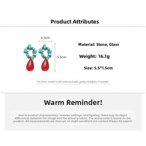 Detailed view of turquoise stone beaded earrings with red teardrop glass pendants