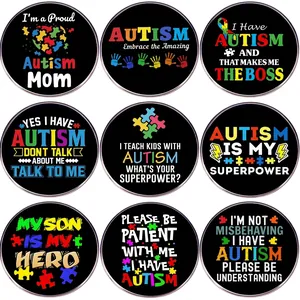 Set of 9 autism awareness pins featuring colorful puzzle patterns and slogans on black pins