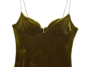 Detailed close-up of olive green velvet dress showing fine straps and sweetheart neckline