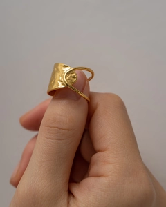 Macro shot of gold hammered texture on geometric stainless steel ring for women