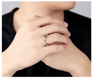 Close-up of a vintage dragon claw ring with silver body and gold tips on a finger