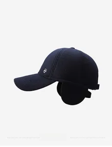 Detail view of winter baseball cap with ear flaps and navy blue wool-like texture