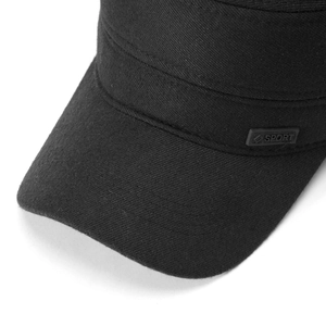 Detail of SPORT metal plaque on side of black winter flat cap for men