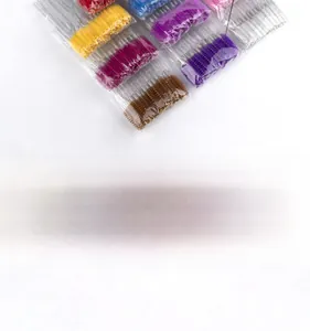 Detailed view of colorful disposable eyelash brushes in organized clear sealed packaging