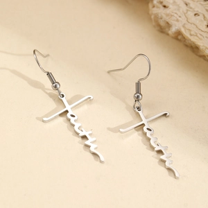 Silver stainless steel long faith cross earrings on a textured stone surface