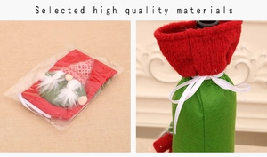 Detail of red and green knitted Christmas gnome wine bottle covers with white ribbons