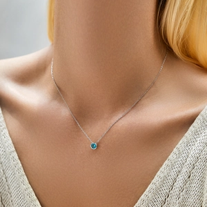 Exquisite S925 silver necklace featuring a round Paraiba blue stone pendant on a model