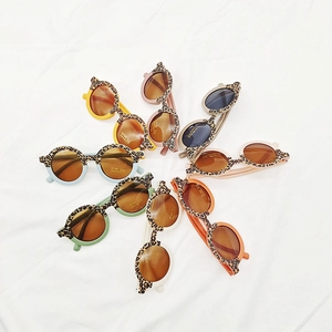 Flat lay of colorful leopard print round children's sunglasses with UV400 protection labels