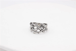 Macro shot of silver gothic ring with intricate dragon totem and flame vine design detail