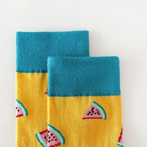 Close-up of blue and yellow cotton socks featuring vibrant watermelon slice pattern
