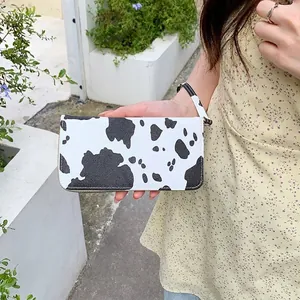 Long cow print PU leather wallet with zipper closure and wristlet strap for women