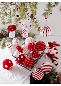 Detailed view of red and white Christmas ornaments including candy canes and flocked mushrooms