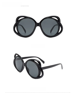 Front and side views of oval hollow frame sunglasses with dark grey lenses in black