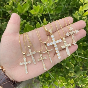 Six 18K gold plated copper cross necklaces with micro-pave zircons in outdoor display