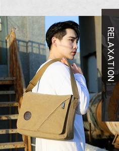 Outdoor shot of khaki canvas messenger bag with adjustable strap and leather emblem