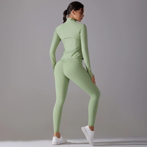 Detail view of light green yoga set with slim fit zip jacket and high waist leggings