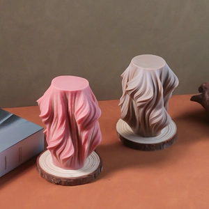 Detailed view of spiral pillar candles in pink and taupe on wooden ring base