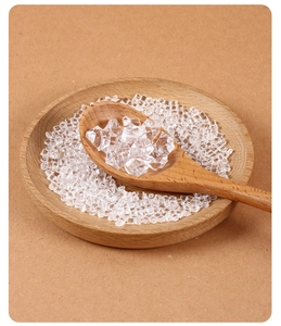 Macro shot of clear acrylic crushed ice and cubes in a wooden spoon for DIY decoration