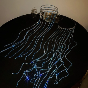 Detail of blue rhinestone long tassel headband with crystal chains on a black pedestal