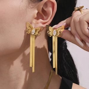 Elegant gold butterfly tassel earrings and ring set with zircon stones on female model