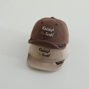 Brown and khaki soft-brim baby baseball caps with embroidered Good Luck smile face logo