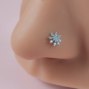 Silver flower nose stud featuring light blue stones on a realistic nose model