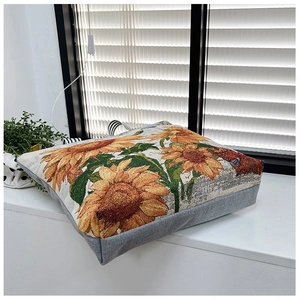Detailed view of yellow sunflower jacquard woven tote bag on a white windowsill