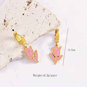 Detail showing 3.4cm length and 6.2g weight for gold pink tulip earrings on stone