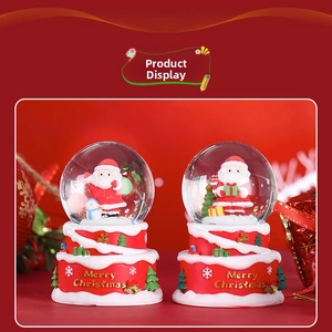 Detail of red Christmas snow globes featuring Santa Claus and Merry Christmas base